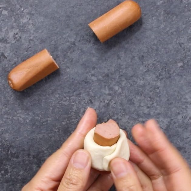 Chili Party Ring - this photo shows how to wrap pieces of hot dig in biscuit dough with your fingers