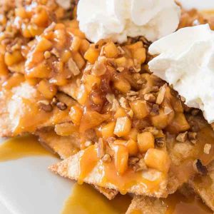 15 Minute Apple Pie Nachos or Apple Pie Bites – delicious cinnamon sugary apple filling on warm, crispy and sweet nachos, topped with pecans, drizzled with caramel sauce, and then topped with whipped cream! The easiest dessert that comes together in no time. It’s the perfect way to serve apple pie to a crowd! Quick and easy recipe. Great for party dessert and holiday brunch such as Easter, Mother’s Day or Father’s Day. Video recipe.