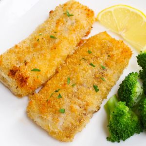 Baked haddock fillets garnished with fresh lemon and served with broccoli