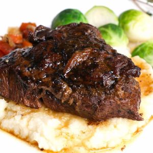 A serving of beef cheeks with mashed potatoes and vegetables