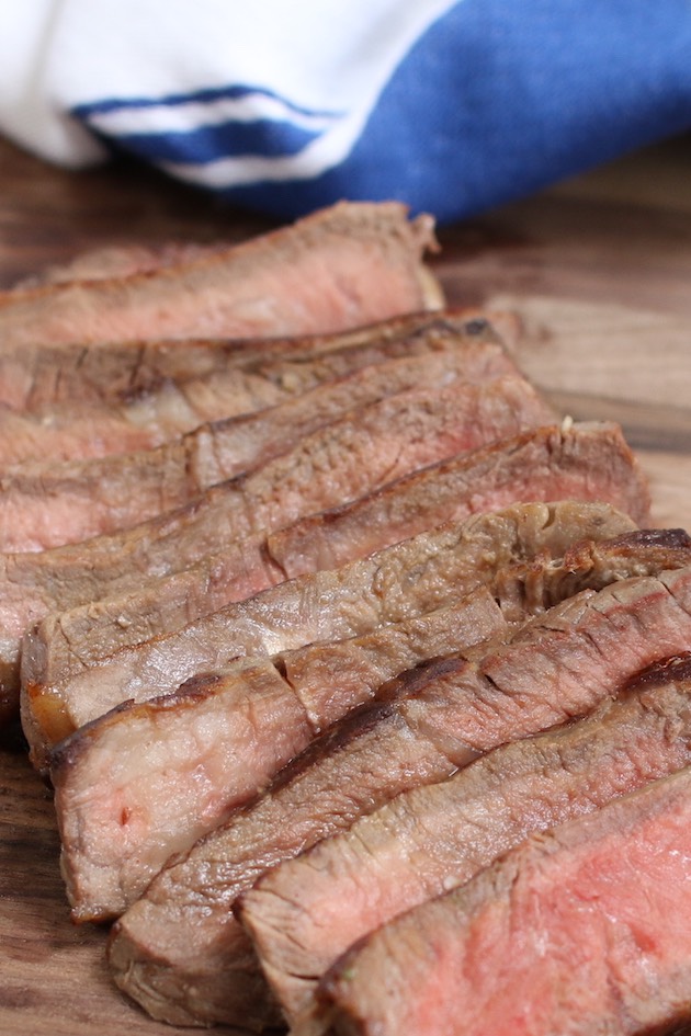 The best steak for tacos is flank steak, skirt steak, sirloin steak or rib eye steak. This photo shows thin slices of grilled sirloin steak cooked medium-rare and ready to be made into tacos