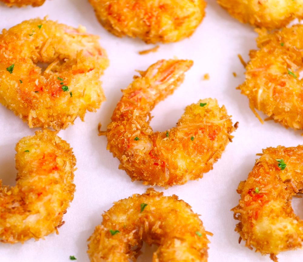 These Coconut Shrimp make an irresistible appetizer that's tender on the inside, and crispy, sweet and crunchy on the outside. They're mouthwateringly delicious and will be the first to go at a party! Plus recipe video tutorial!