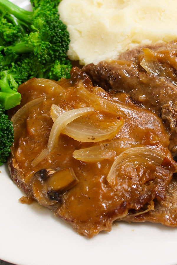 Crock Pot Cube Steak and Gravy made with tender and succulent cubed steak smothered in a rich and divine mushroom sauce in a slow cooker. Serve it with mashed potatoes and green vegetable, and then drizzle with the thick and flavorful gravy for a perfect home-style dinner!