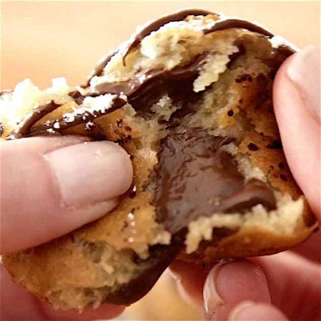 Closeup of pulling apart a fried cookie dough bite revealing the melty, chocolatey goodness inside! 