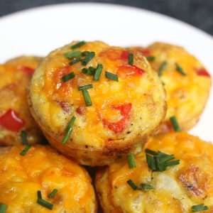 These freezer-friendly Egg Muffins are made with eggs, cheese, bacon, spinach, onions, and bell peppers. An easy make-ahead recipe, they only take a few minutes to throw together. These breakfast muffins are delicious, healthy and nutritious, perfect for busy mornings!