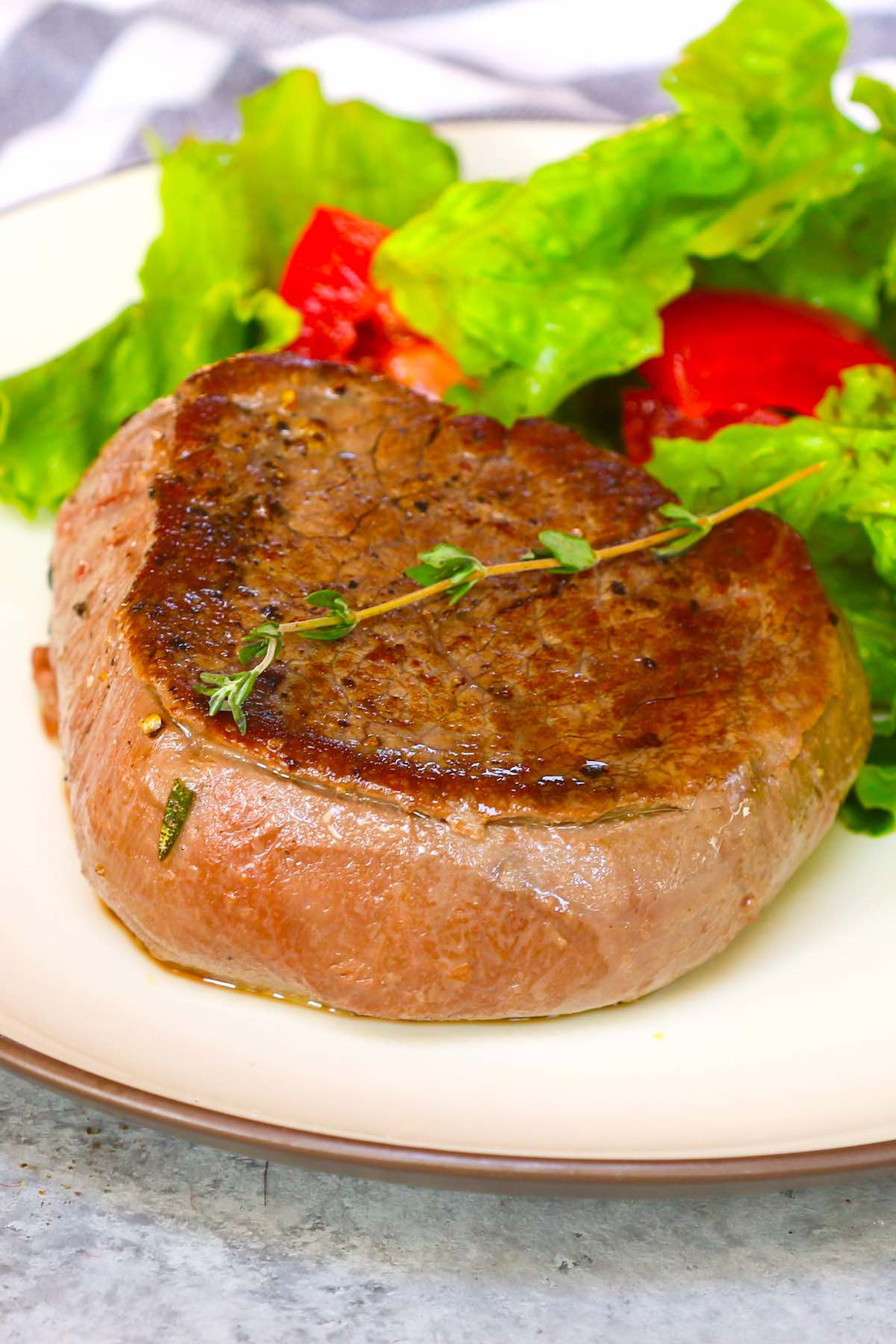 Tenderloin steak served with a side salad