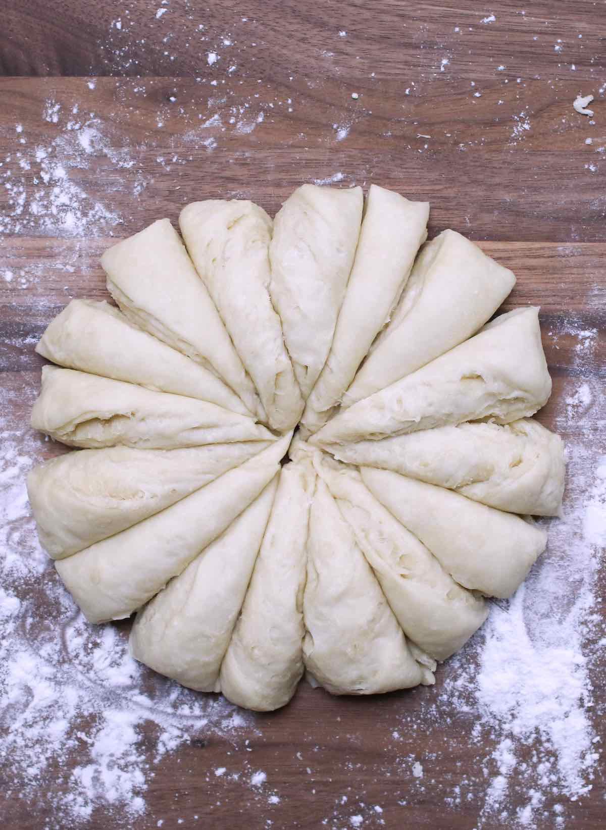 Divide the dough into 16 small portions on the cutting board.