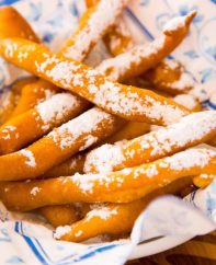 Easy Funnel Cake Fries – delicious cake batter is fried to perfect golden crispy fries. Served with some caramel sauce or a marshmallow dip! You can make the cake batter following our tutorial or get a funnel cake mix from your grocery store. So yummy! Great for snack, parties, or dessert! Quick and easy recipe. Video recipe. | Tipbuzz.com
