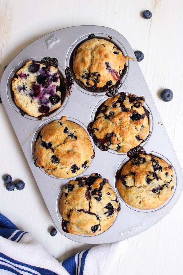 Overhead view of six blueberry muffins showing the moist and fluffy texture with blueberries interspersed, such a delicious snack or breakfast idea