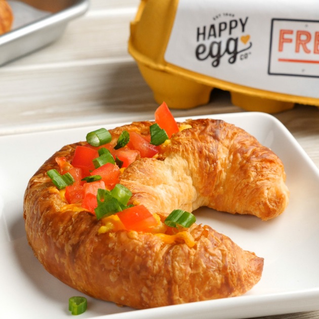 Holiday Croissant Boats are a baked breakfast with fluffy ham and cheese omelet baked inside of a crispy croissant