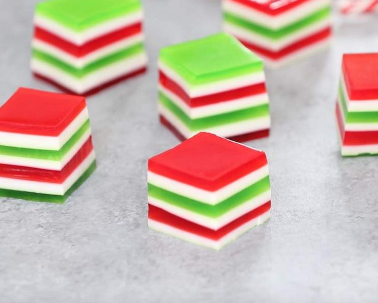This closeup photo shows the beautiful red, green and white layers in Layered Jello Shots