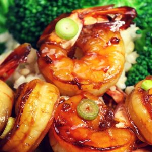 Honey garlic shrimp with a side of broccoli on a bed of steamed rice