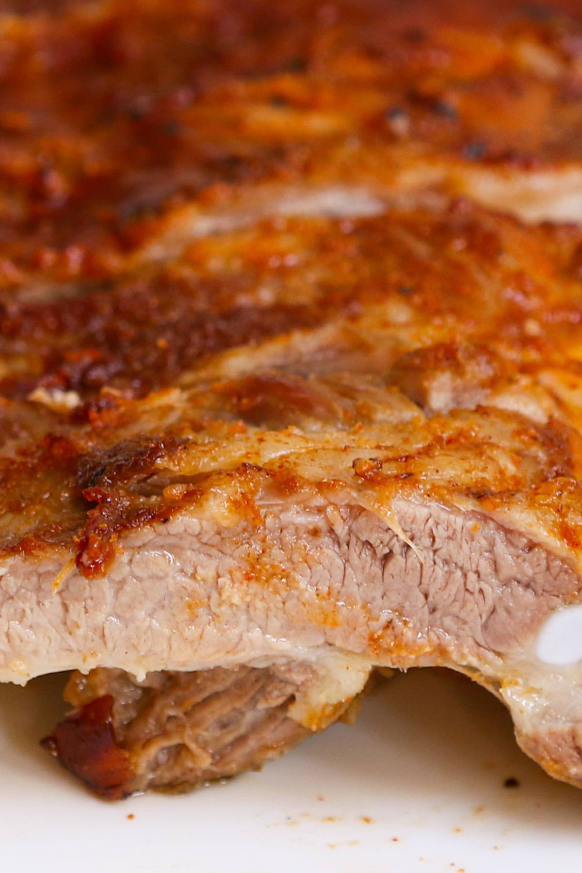 Closeup of an individual rib baked to perfection with juicy meat and a caramelized crust