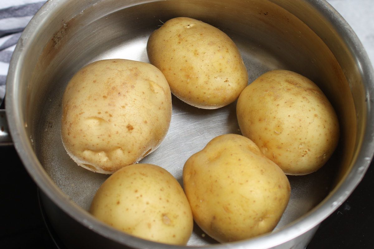 Round white potatoes in a medium pot before adding water for boiling