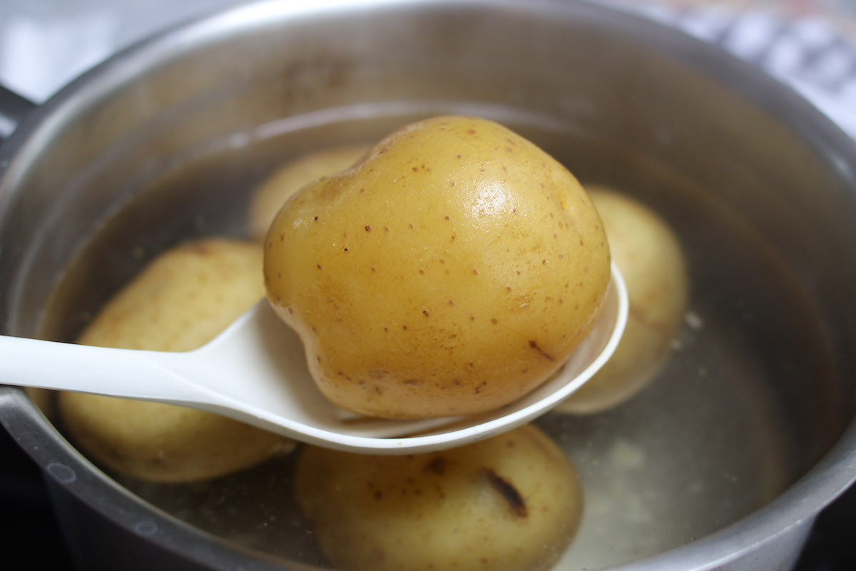 Closeup of a round white potato that has been boiled until tender