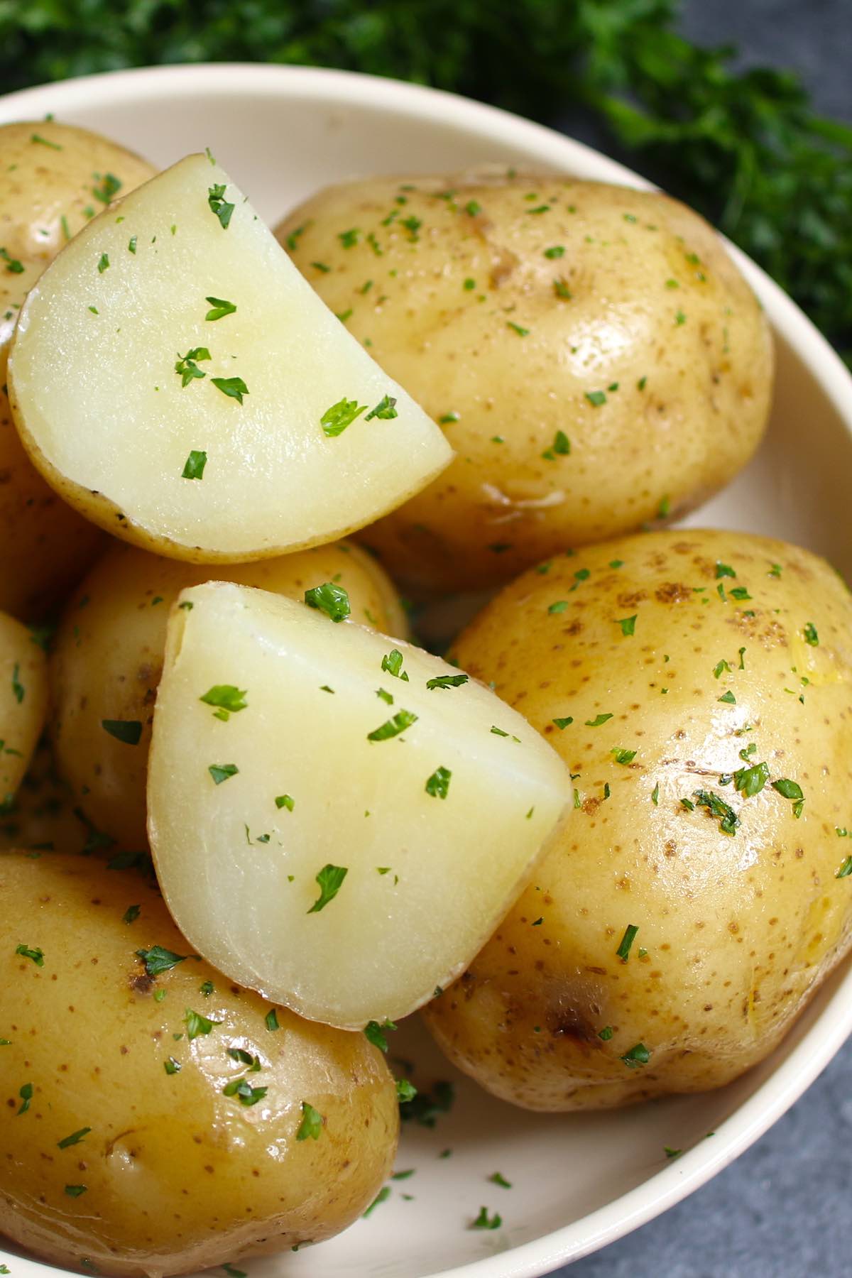 Freshly boiled potatoes served simply with butter and fresh parsley for an easy side dish