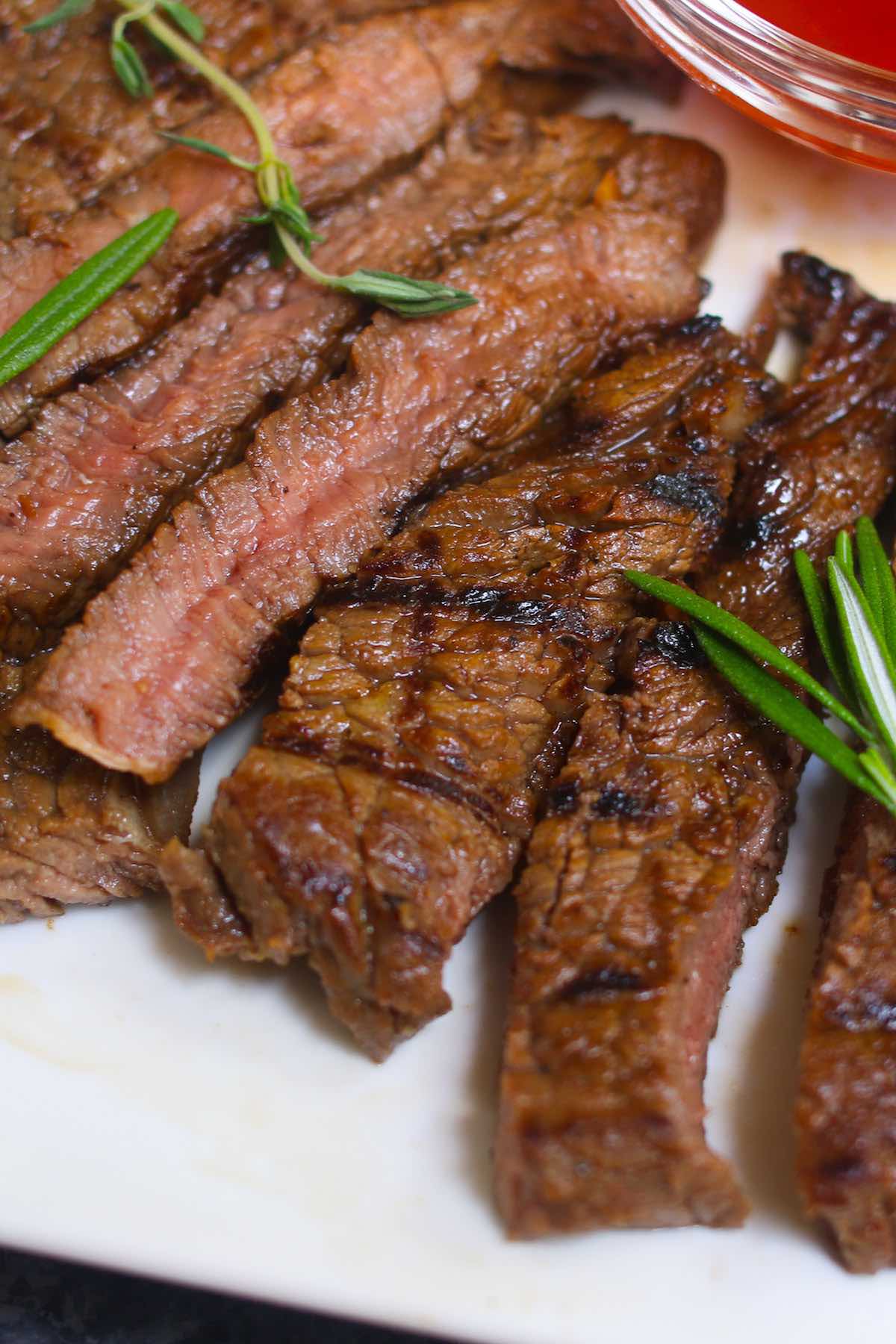 Closeup of perfectly grilled steak with crosshatch grill marks and a tender and juicy interior