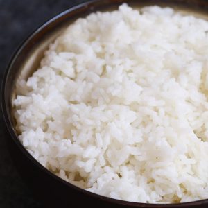 Fluffy microwave rice in a serving bowl ready to combine with other dishes to make a delicious meal