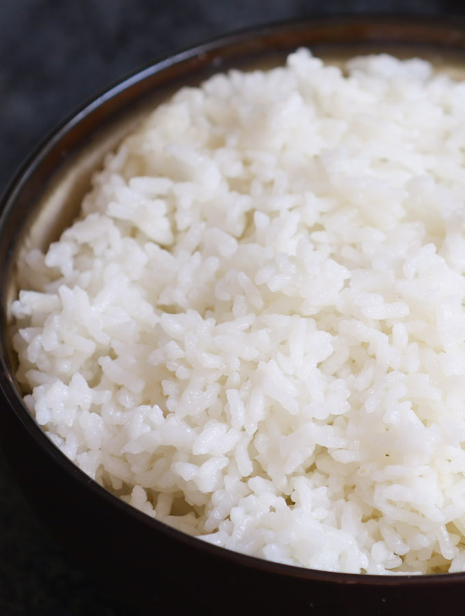 A bowl of microwave white rice showing fluffy texture of the grains for an easy side dish that's ready in minutes