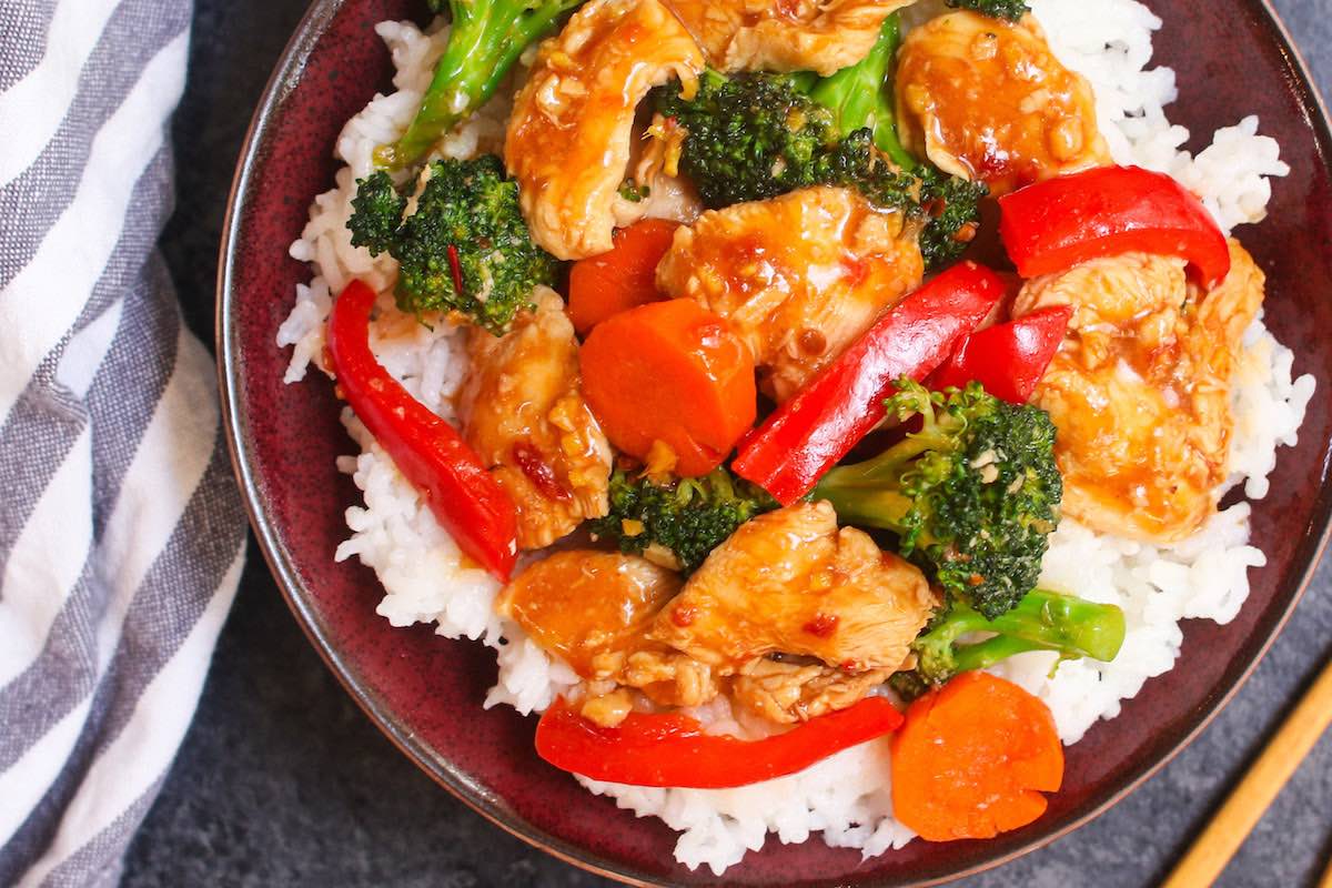 Closeup of a Hunan Chicken recipe served in a rice bowl