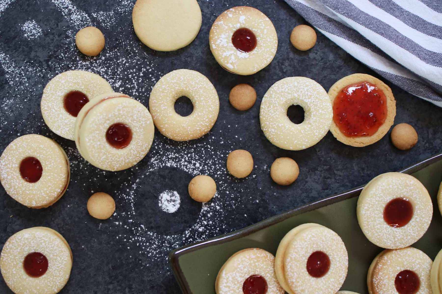 Assembling Jammie Dodgers after the top layers were dusted with icing sugar.