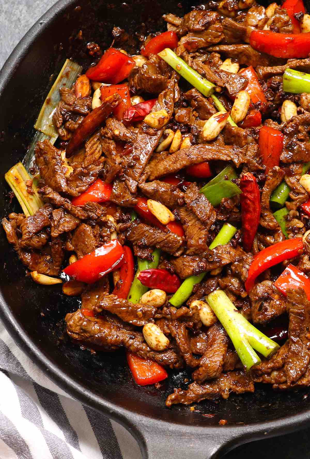 Stir fried Szechuan beef and vegetables in a cast iron skillet