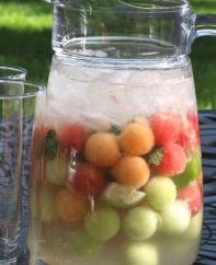 A pitcher of watermelon mojito with highball glasses - the perfect summer cocktail!
