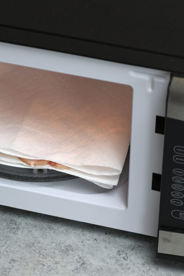 Placing a paper towel lined plate into a small microwave