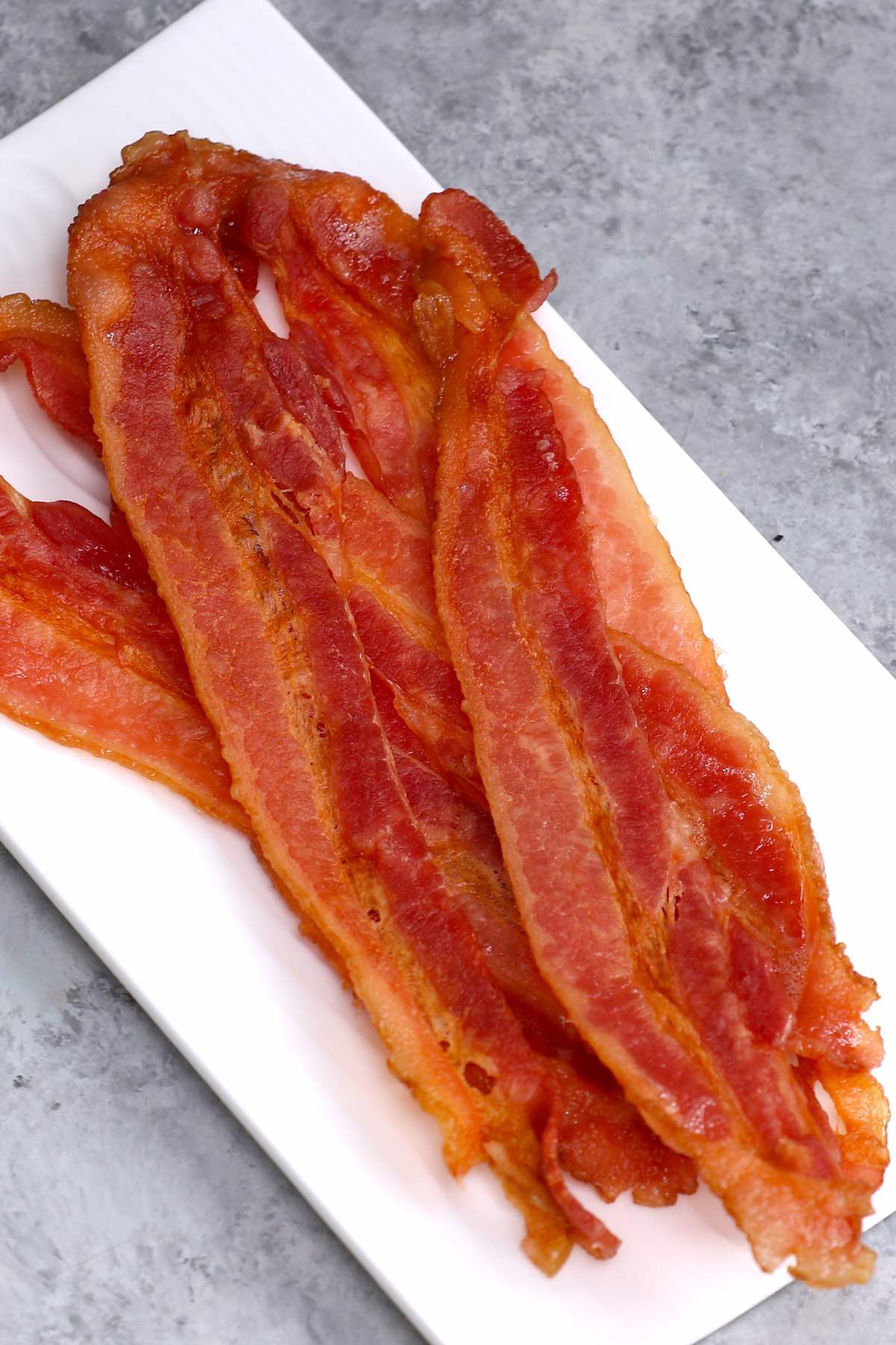 Strips of crispy microwaved bacon on a serving plate #microwavebacon
