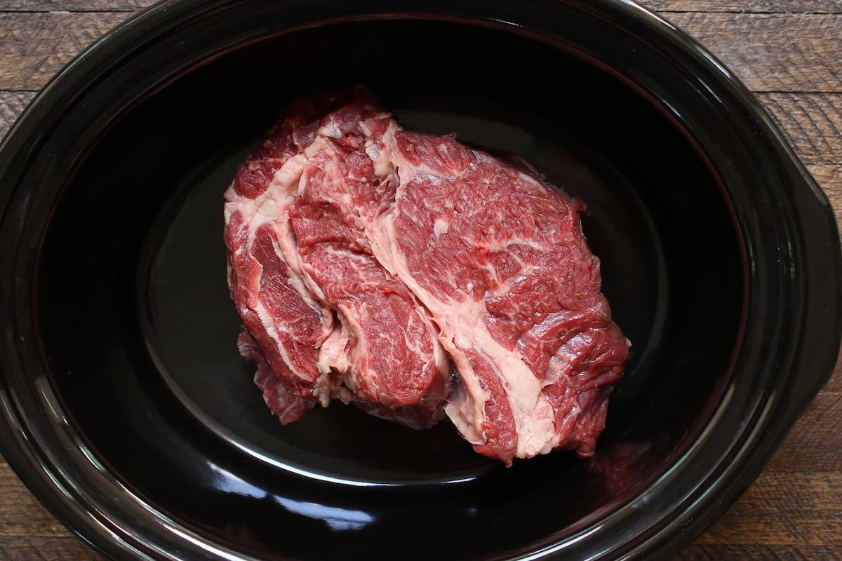 Place the chuck roast in the crockpot.