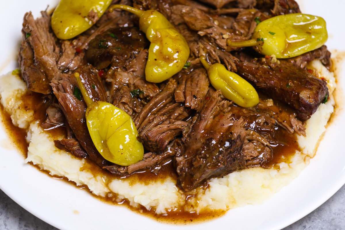 Mississippi pot roast served with gravy on mashed potatoes.