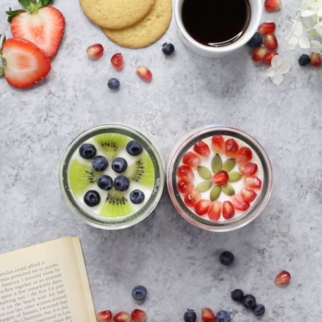 This is an overhead photo of two Oui By Yoplait French-style yogurt pots decorated with fresh fruits, biscuits and a hot beverage for the perfect DIY me moment