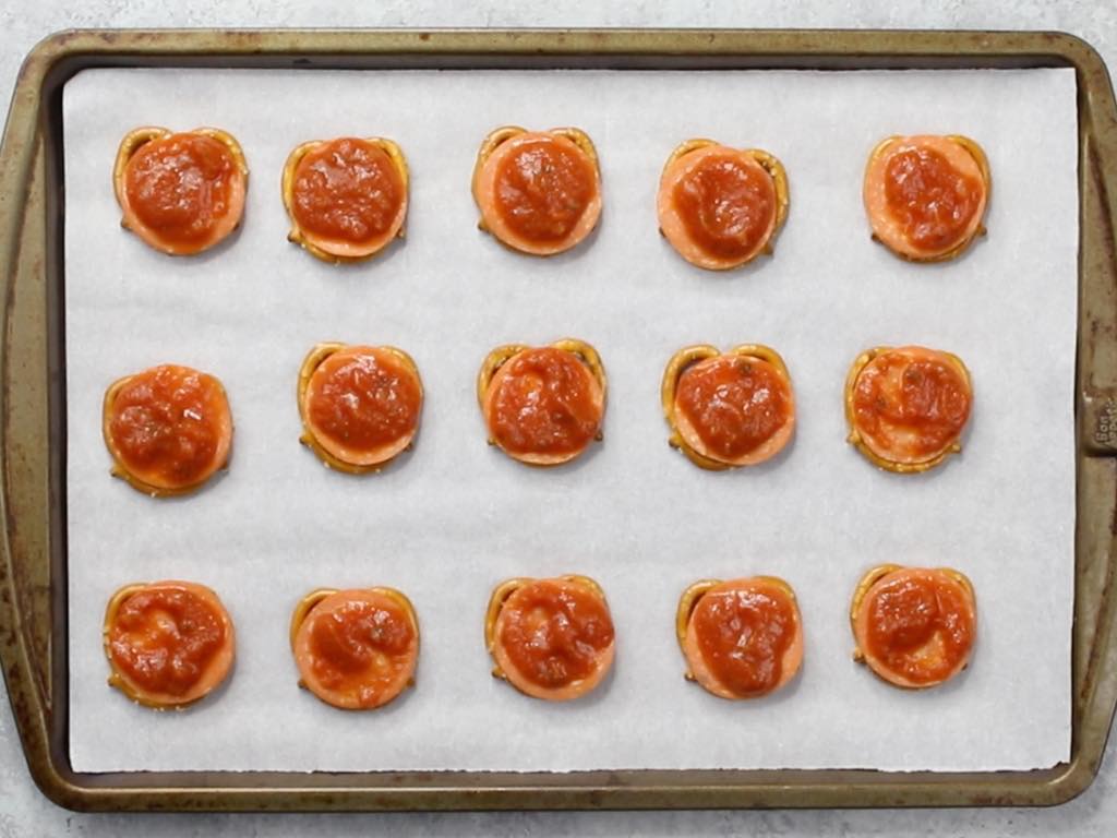 This is a photo of pizza pretzels with sauce on top of the pepperoni
