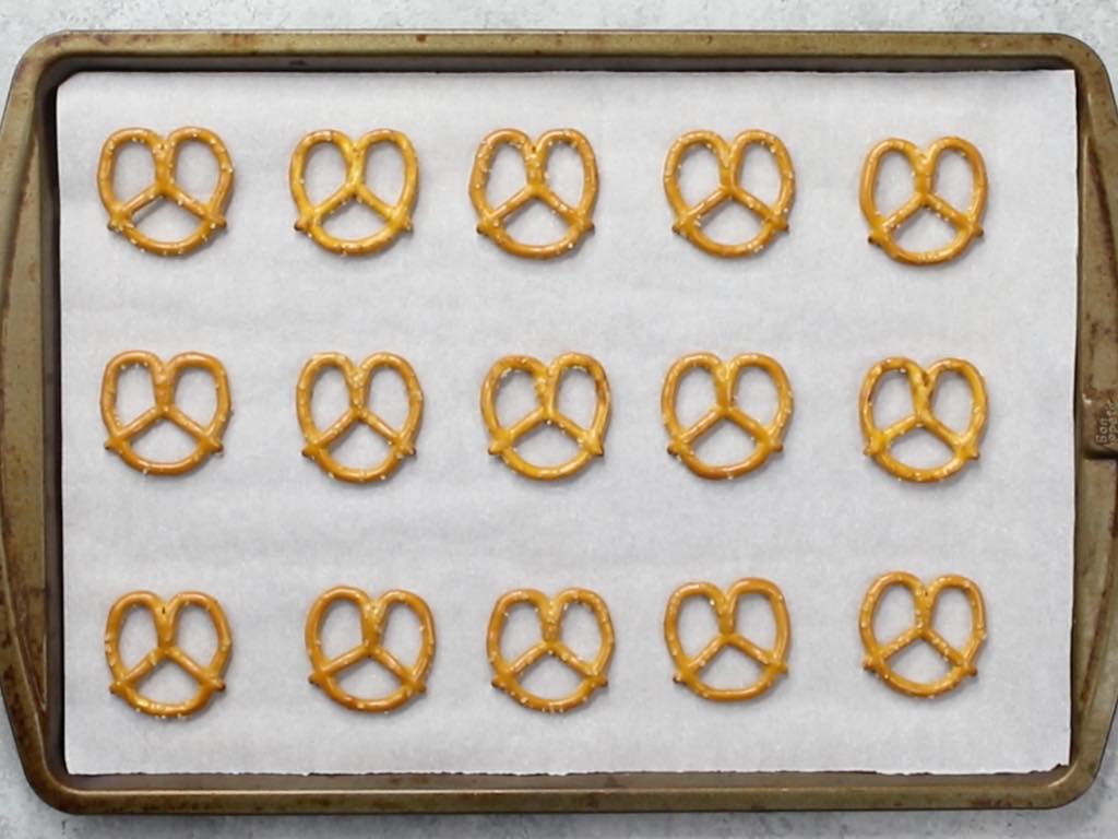 This photo shows pretzels arranged on a baking sheet lined with parchment paper