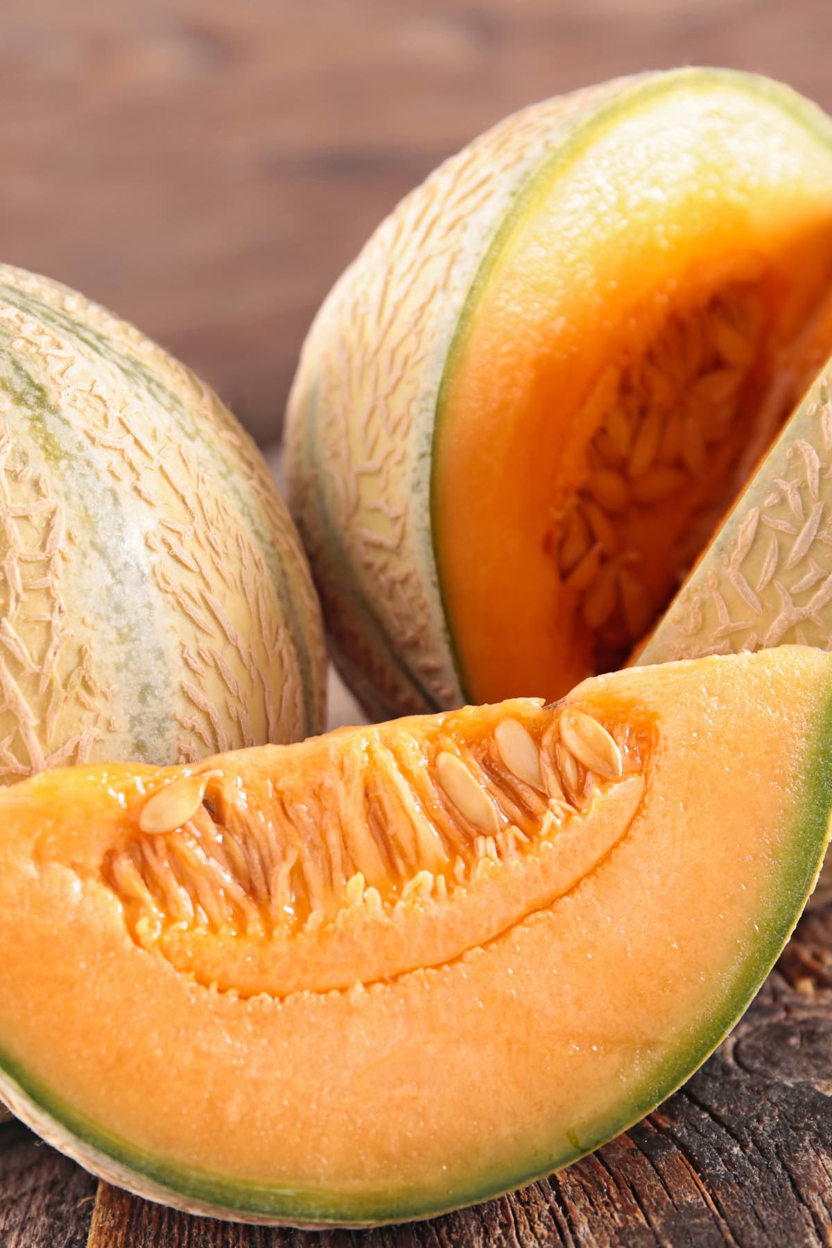 Wedges of ripe cantaloupe with bright, coral-colored flesh