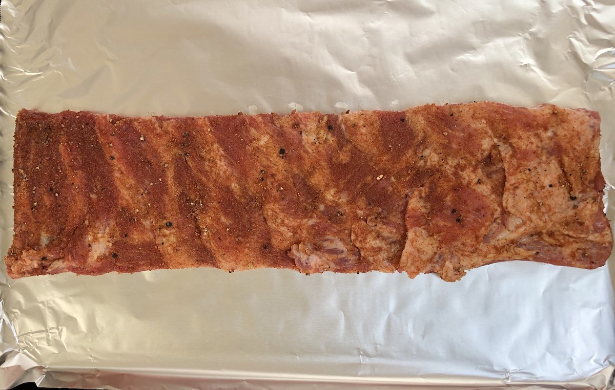 A rack of St Louis ribs after being rubbed with a seasoning mixture