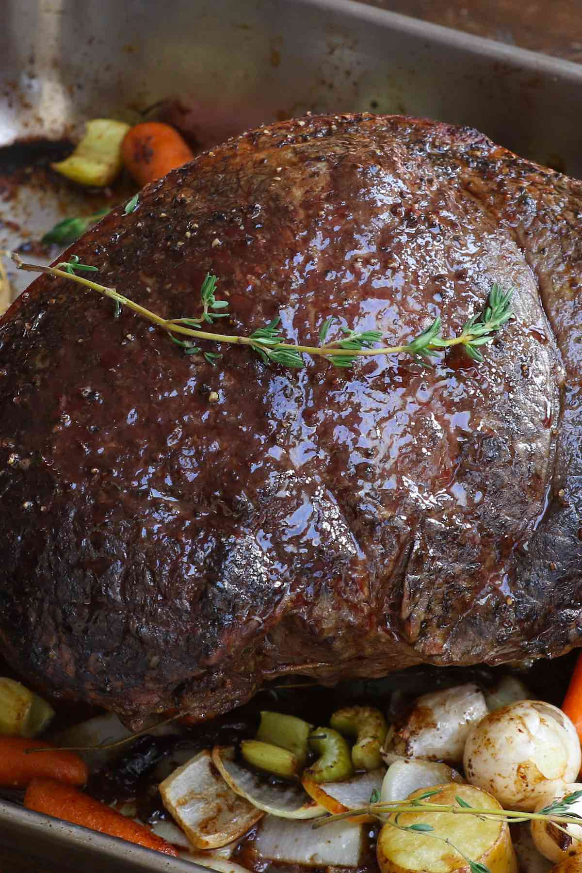 Sirloin roast in a roasting pan with vegetables