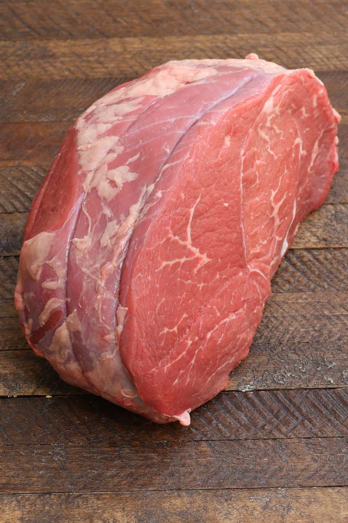 An raw 4-pound sirloin tip roast showing the lean texture of the meat