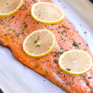 A fillet of sockeye salmon baked to perfection on a serving plate