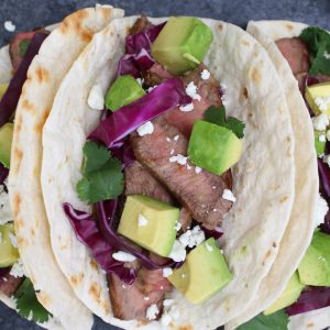 Homemade steak tacos made with sirloin steak, hot flour tortillas, toppings and queso fresco cheese for a delicious lunch or dinner idea