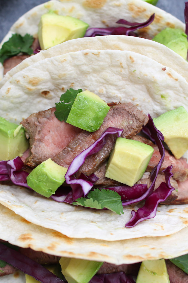 A simple steak taco made with steak, tortilla and a few toppings without cheese