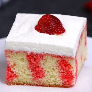 Strawberry Jello Poke Cake is a traditional southern dessert featuring a cake layer imbued with strawberry jello, a creamy topping and fresh strawberries on top