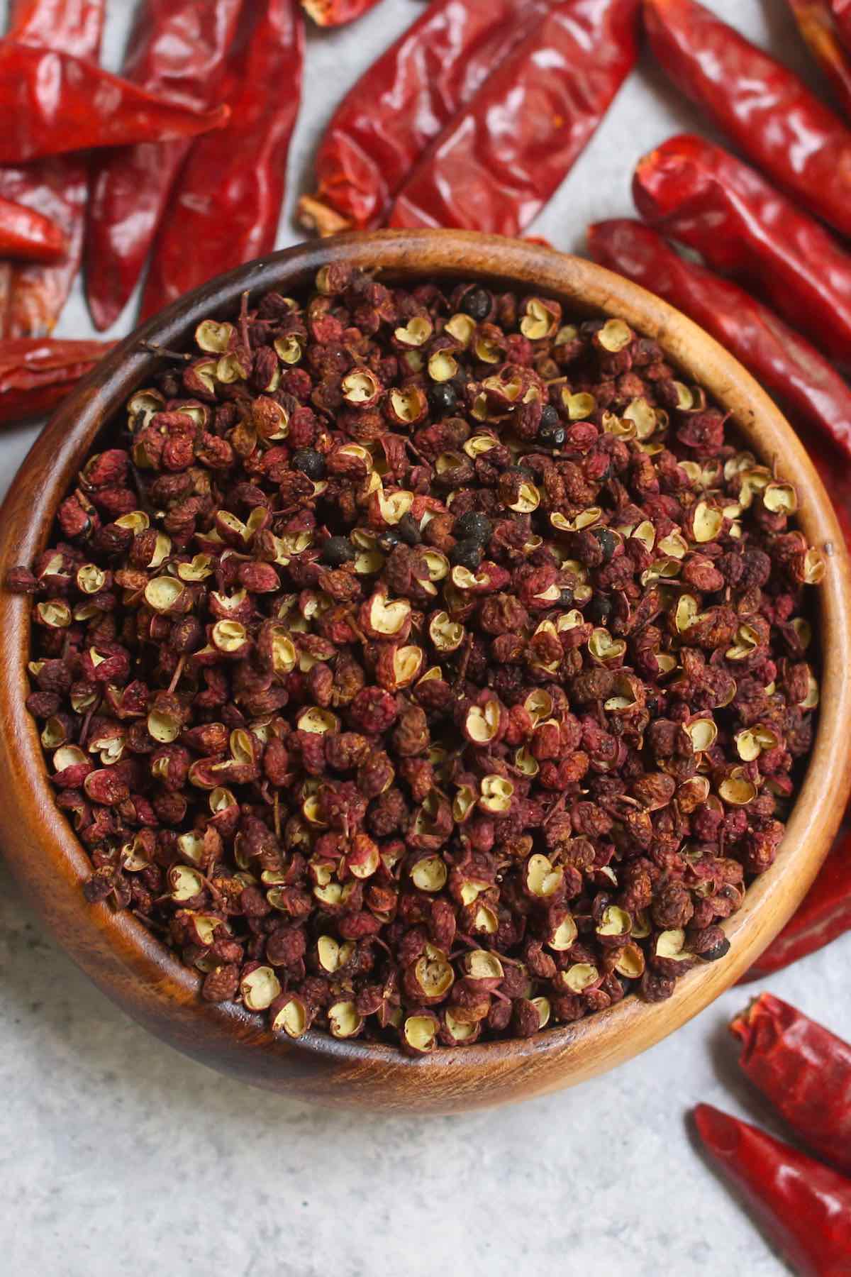 Szechuan peppercorns in a wooden bowl.