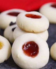 These classic Thumbprint Cookies combine soft, buttery shortbread cookies with your favorite fillings for the perfect Christmas treat! The dough is made with just 5 simple ingredients, and then rolled into individual balls. Use your thumb to make an imprint before filling with your favorite jam, chocolate or other delicious fillings!
