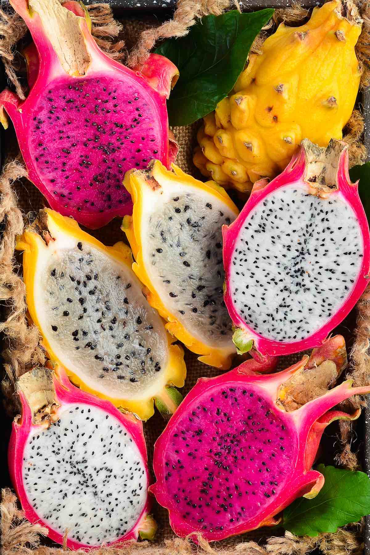 Side-by-side comparison of red, white and yellow dragon fruit showing the different colors and textures of the flesh