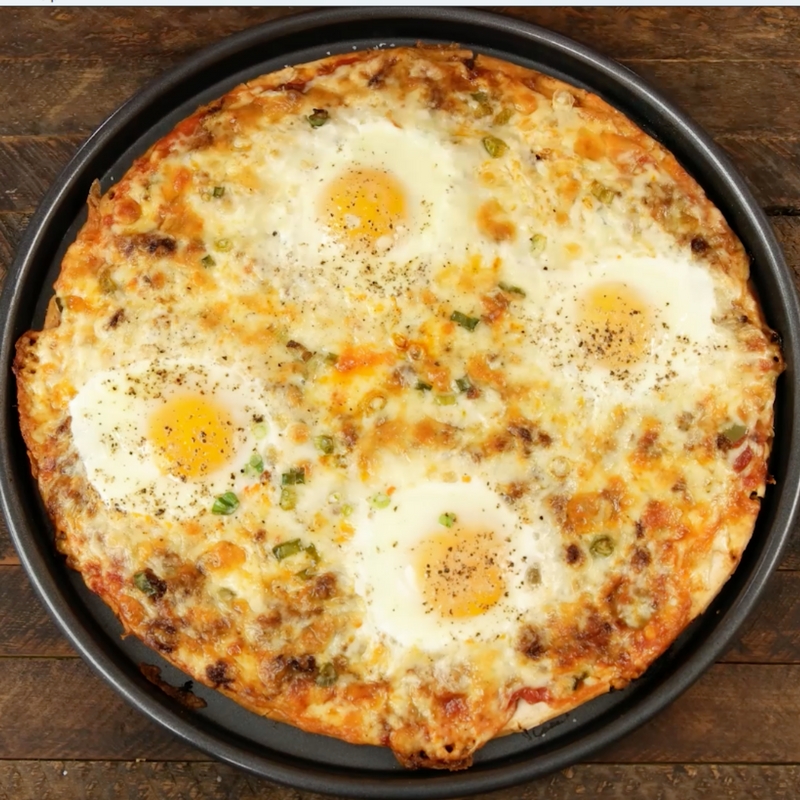 Easy Cheesy Breakfast Pizza With Sausage And Eggs – the easiest and fun breakfast that comes together in no time. All you need is a few simple recipes: your favorite sausage, pizza crust, salsa, green onions, Jack cheese, eggs, salt and pepper. It’s the perfect hearty breakfast or brunch recipe to serve to a crowd! Great for a holiday such as Easter, mother’s day or father’s day brunch. Quick and easy video recipe. | Tipbuzz.com