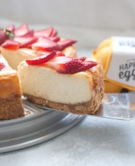 A slice of strawberry white chocolate cheesecake being served