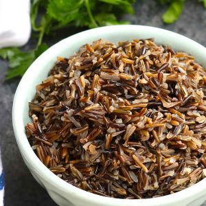 A bowl of fluffy wild rice showing its beautiful fluffy texture and dark brown color